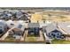 Rear view of a two-story home with a small yard, fencing and a park across the street at 6707 6Th St, Frederick, CO 80530