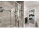 Beautiful gray tile shower with glass door and chrome fixtures at 6707 6Th St, Frederick, CO 80530