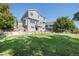 Back exterior of the two-story house featuring a well-maintained lawn and backyard patio at 6833 E 115Th Ave, Thornton, CO 80233