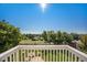 Expansive backyard view from deck features mature trees, green grass, and a charming stone fire pit area at 6833 E 115Th Ave, Thornton, CO 80233