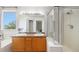 Bathroom featuring dual sinks, a shower, a soaking tub, and natural light from a window at 6833 E 115Th Ave, Thornton, CO 80233