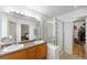 Bathroom with tiled flooring, double sink vanity, shower, and a walk-in closet at 6833 E 115Th Ave, Thornton, CO 80233