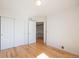 Bedroom showcasing hardwood floors, closet, and view to the stairway at 6833 E 115Th Ave, Thornton, CO 80233
