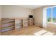 Bedroom featuring a custom built-in desk with storage and shelving, and wood floors at 6833 E 115Th Ave, Thornton, CO 80233