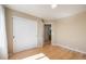 Bedroom with wood floors, closet, and doorway to ensuite bathroom at 6833 E 115Th Ave, Thornton, CO 80233