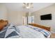 Bedroom with wood floors, ceiling fan, closet, and mounted television at 6833 E 115Th Ave, Thornton, CO 80233