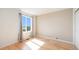 Bright bedroom featuring hardwood floors, a large window, and neutral-colored walls at 6833 E 115Th Ave, Thornton, CO 80233