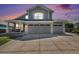 Charming two-story home featuring a two-car garage and covered porch entrance at 6833 E 115Th Ave, Thornton, CO 80233