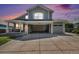 Charming two-story home featuring stone accents, a covered porch, open garage space, and a well-maintained lawn at 6833 E 115Th Ave, Thornton, CO 80233