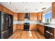 Well-lit kitchen with stainless steel appliances, ample cabinetry, and hardwood floors at 6833 E 115Th Ave, Thornton, CO 80233