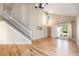 Inviting living room with hardwood floors, high ceilings, staircase, and natural light at 6833 E 115Th Ave, Thornton, CO 80233