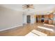 Open-concept living space with hardwood floors seamlessly connects the living room and kitchen at 6833 E 115Th Ave, Thornton, CO 80233