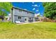 Expansive backyard offers a patio with seating, lounge furniture, and green lawn, perfect for outdoor relaxation at 10925 W Montana Pl, Lakewood, CO 80232