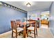 Bright dining room featuring blue walls and wood furniture at 10925 W Montana Pl, Lakewood, CO 80232