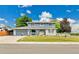 Charming two-story home features a landscaped front yard and a cozy front porch at 10925 W Montana Pl, Lakewood, CO 80232