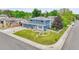 Beautiful home with lush front yard, driveway, and solar panels, showcasing curb appeal and sustainable features at 10925 W Montana Pl, Lakewood, CO 80232