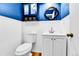 Clean half bathroom with white wainscotting, a pedestal sink and toilet at 10925 W Montana Pl, Lakewood, CO 80232