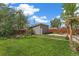 Spacious backyard featuring a shed, lawn, garden, and privacy fence at 2965 Ivy St, Denver, CO 80207