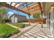 Inviting backyard with a pergola, landscaping, patio, and detached garage at 2965 Ivy St, Denver, CO 80207