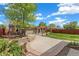 A beautiful backyard featuring a large patio, pergola, and lush landscaping at 2965 Ivy St, Denver, CO 80207