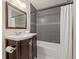 Updated bathroom with a modern vanity, shower with gray tiles, and white walls at 2965 Ivy St, Denver, CO 80207
