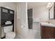 Modern bathroom with storage, a shower with gray tiles, and contemporary features at 2965 Ivy St, Denver, CO 80207