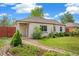 Charming home with a well-maintained lawn, stone accents, and mature trees at 2965 Ivy St, Denver, CO 80207