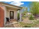 Inviting front porch with chairs, decorative rug, and stone landscaping at 2965 Ivy St, Denver, CO 80207