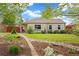 Charming single-story home boasts a landscaped front yard with a stone pathway at 2965 Ivy St, Denver, CO 80207