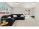 Bright living room features a large sectional couch and sliding doors to the backyard at 2965 Ivy St, Denver, CO 80207