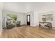 Light-filled living room features new flooring, neutral paint, and an ornate front door at 2965 Ivy St, Denver, CO 80207