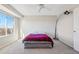 Bright bedroom featuring a ceiling fan, large window, and modern lighting at 11293 Latigo Ln, Parker, CO 80138