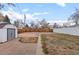 Large backyard with shed and partially fenced area, perfect for outdoor activities at 2248 Lima St, Aurora, CO 80010