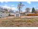 Expansive backyard with storage shed, brick patio, gravel area, and partial grass at 2248 Lima St, Aurora, CO 80010