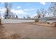 Wide-open backyard featuring white fencing, shed, parking area, and partial gravel cover at 2248 Lima St, Aurora, CO 80010