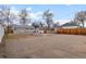 Extensive backyard with large parking area, shed, and partial fencing at 2248 Lima St, Aurora, CO 80010