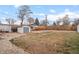 Spacious backyard with shed, brick patio, gravel area, and green grass at 2248 Lima St, Aurora, CO 80010
