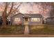 Charming single-story home with neutral siding, a fenced yard, and mature trees at 2248 Lima St, Aurora, CO 80010