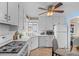 Cozy kitchen space with white cabinetry, efficient appliances, and sunny breakfast spot at 2248 Lima St, Aurora, CO 80010