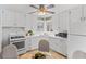 Well-lit kitchen featuring white cabinets, modern appliances, and a corner sink with a window at 2248 Lima St, Aurora, CO 80010