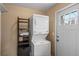 Convenient laundry room with a stackable washer and dryer, plus storage shelves at 2248 Lima St, Aurora, CO 80010