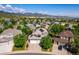 Stunning aerial view of a home with solar panels in a scenic neighborhood with mountain backdrop at 9745 Hummingbird Pl, Littleton, CO 80125