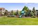 Fenced backyard with a playset, swing set, and trampoline at 9745 Hummingbird Pl, Littleton, CO 80125