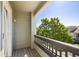 Cozy outdoor balcony space with wood decking and a view of mature trees at 9745 Hummingbird Pl, Littleton, CO 80125