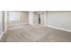 Finished basement with neutral carpet and trim, bright natural light from a window at 9745 Hummingbird Pl, Littleton, CO 80125