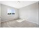 Neutral bedroom with carpet, light gray walls and a large window overlooking the neighborhood at 9745 Hummingbird Pl, Littleton, CO 80125