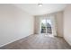 Carpeted bedroom with a sliding glass door that leads to a private balcony at 9745 Hummingbird Pl, Littleton, CO 80125