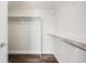 Spacious walk-in closet with wood-look floors and multiple rods and shelves for optimal storage at 9745 Hummingbird Pl, Littleton, CO 80125