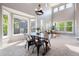 Bright dining room area with large windows, neutral paint, and modern fixtures at 9745 Hummingbird Pl, Littleton, CO 80125