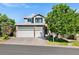 Charming two-story home with a three car garage, and mature landscaping at 9745 Hummingbird Pl, Littleton, CO 80125